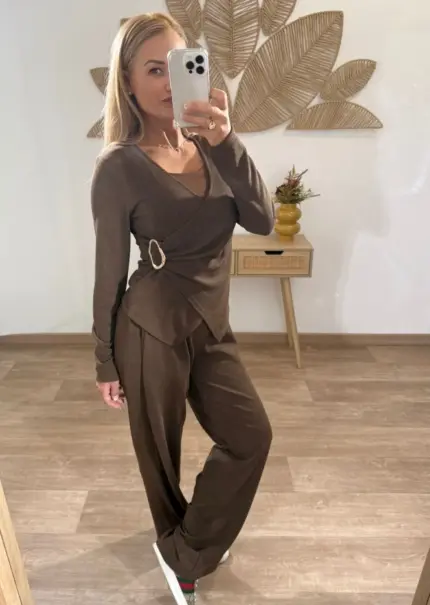 Mujer con conjutno de dos piezas, camiseta cruzada con detalle lateral y pantalón fluido, estilo casual elegante.